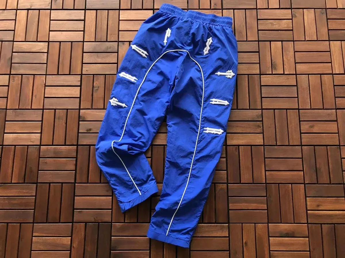 Blue Track Pants with White Arrow Details