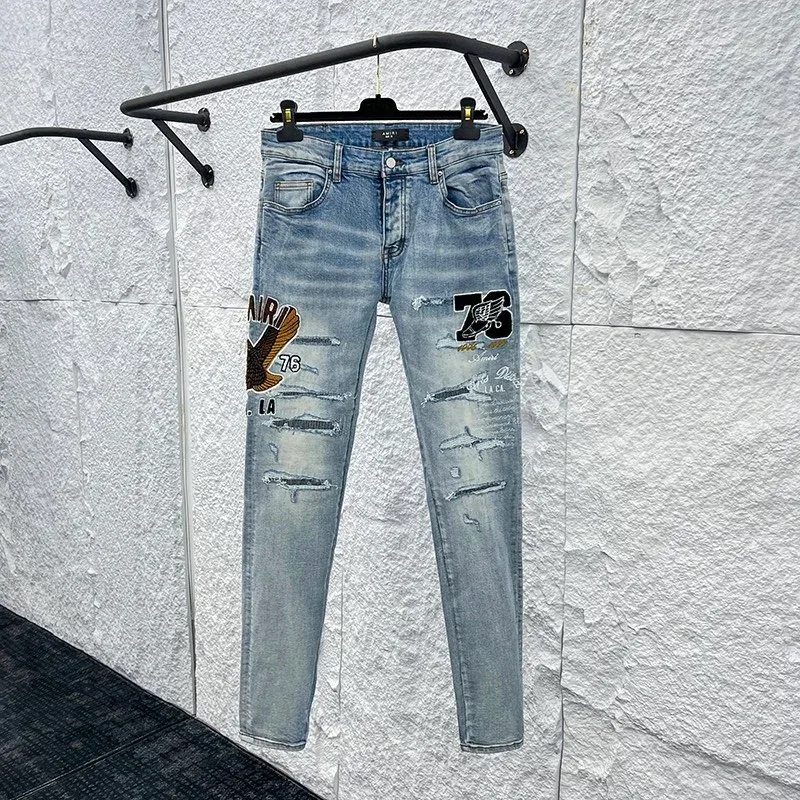 Light Blue Distressed Jeans with Graphic Patches
